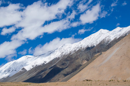 Beautiful snow peaks, high ridge mountains of Ladakh with beautiful blue sky background, Changla Pass, Jammu and Kashmir, India, Blue shy with white clouds in the background, scenic image.の写真素材