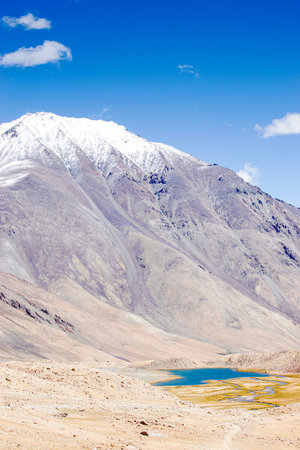 View of lake and river with snowy mountain peak at Chang La , southern pass, a high mountain pass in...