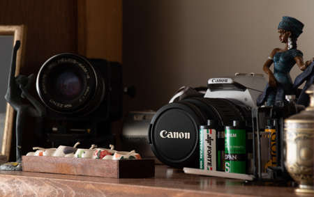 decoratively placed old generation 35mm black-white films and old camerasのeditorial素材