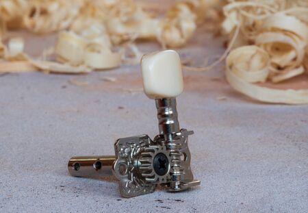 single tuning peg for classical guitar on the workbenchの写真素材