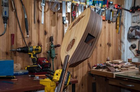 assembly of undersaddle equalizer into the lavta musical instrument in atelierの写真素材