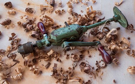 a very rare vintage / antique hand drill for carpentry on the workbenchの写真素材