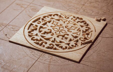 CNC machine has yet routed wood for cutting an oud / guitar hole cover cage awayの写真素材