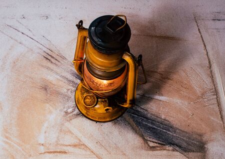 very old, used vintage metal gas light, as an ancient rusty object on the dusty platformの写真素材