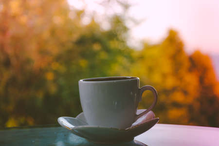 a coffee cup, traditional turkish coffee on the table in outdoor place with colorful nature blur background.の写真素材