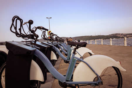 city bikes stay in-line on the sea side, rent a bike, urban life style.のeditorial素材