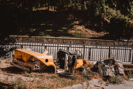 after some time of a car crash, broken and desolated cars stay on the side of the highway.のeditorial素材