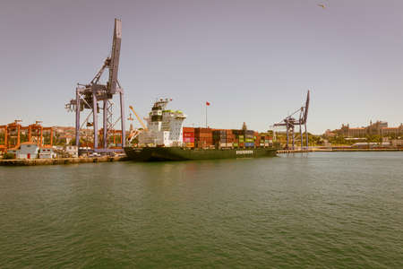 Huge cranes load a ship on the sea freight loading platform.のeditorial素材