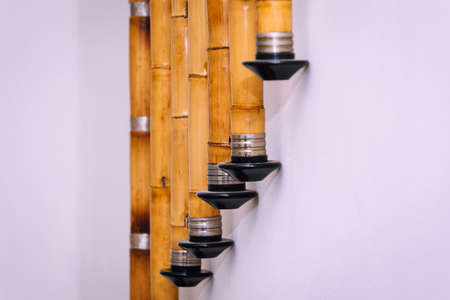 A group of musical wind instrument Ney hanging on the wall, closeup.の写真素材