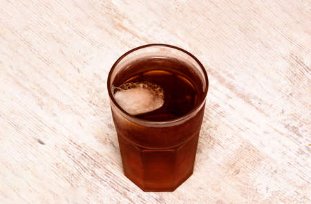 a large glass of iced tea on the table, isolated.の写真素材