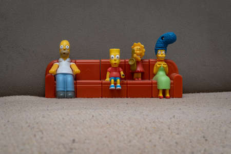 Original plastic figures, toy characters of Simpsons family sitting on sofa together, 29 years old legendary symbol of cartoon TV shows.のeditorial素材