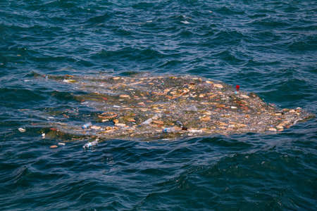 closeup view of the sea pollution in metropolis city, civilization waste on the sea surface.の写真素材