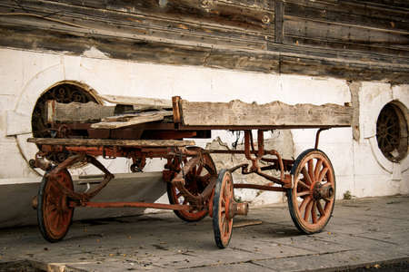 an old four-wheeled horse-drawn carriage stays abandoned. old cart carriage or horse wagon without...
