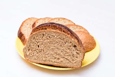 fresh buckwheat bread served cut and sliced on the white table. white background close-up, isolated.の写真素材