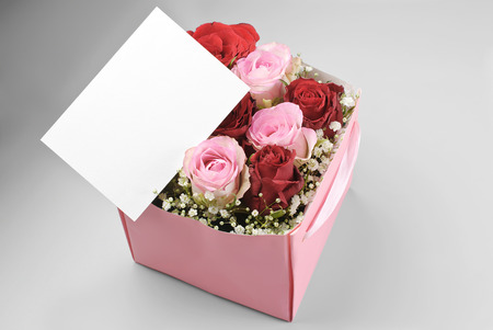 Blank greeting card over decorative box of rosesの写真素材