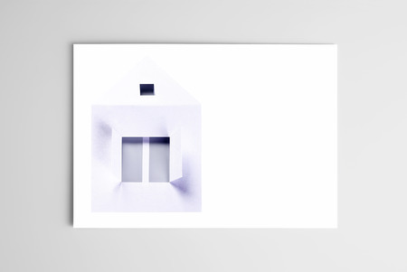 Blank open card with paper houseの写真素材