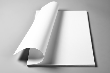 Heap of blank sheets of paper with curled upper pageの写真素材