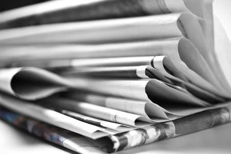 Stack of old folded newspapers, selective focus