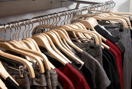 Modern women clothes on wooden hangers