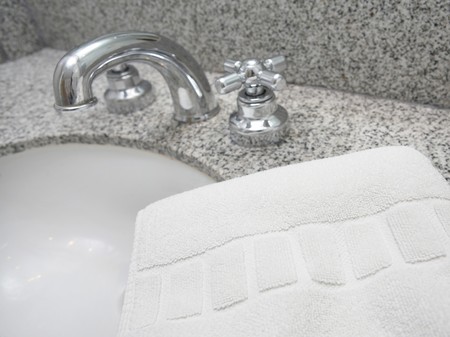 White towel and metal tap background in modern bathroomの写真素材
