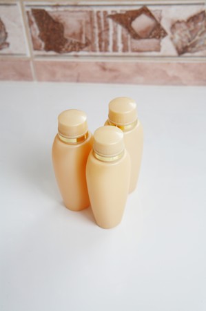 Three no name same cream tube on a white sinkの写真素材