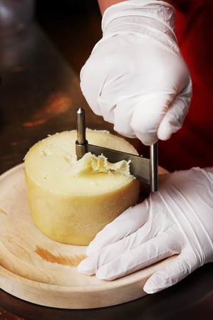 Cutting cheese with special equipmentの写真素材