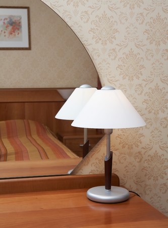Lamp in front of mirror in a modern bedroom  の写真素材