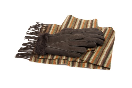 Brown suede gloves and striped wool scarf solated on whiteの写真素材