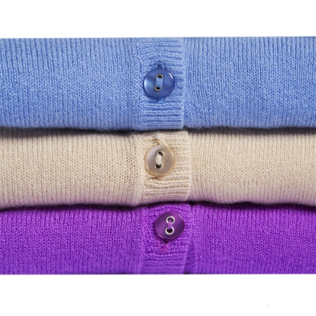 Pile of multicolored knitted women clothes macroの写真素材