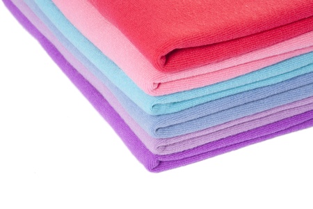 Pile of multicolored textile clothes on whiteの写真素材