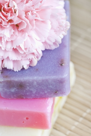 Three soap bars with natural ingredients and flower macroの写真素材