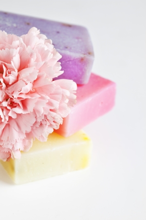 Three soap bars with natural ingredients and flowerの写真素材