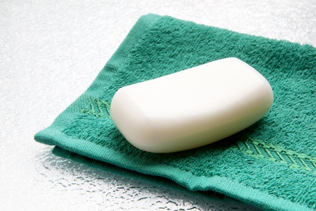 White soap bar on double towel