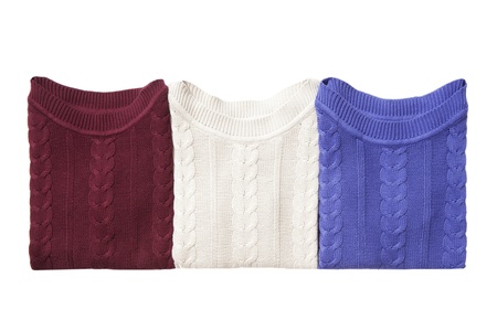 Three folded sweaters isolated on whiteの写真素材