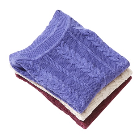 Pile of three folded sweaters isolated on whiteの写真素材
