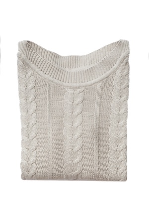 Beige folded sweater isolated on whiteの写真素材