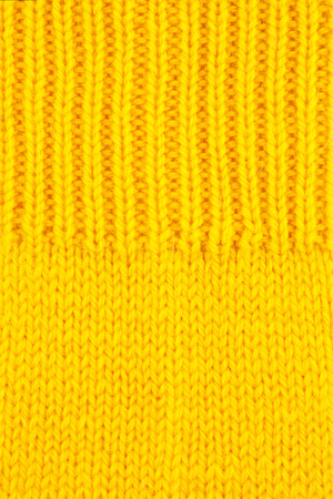 Yellow wool knitted textured backgroundの写真素材