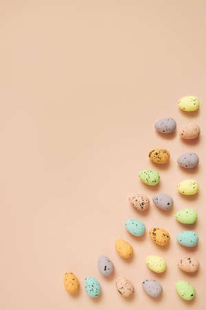Easter eggs decoration minimal vertical layout on peach color backgroundの写真素材