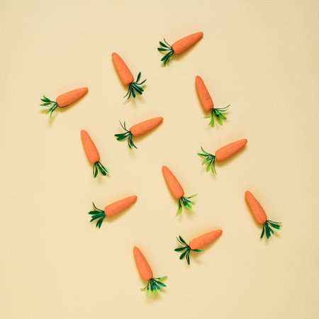 Artificial carrots lay down on pastel background pattern