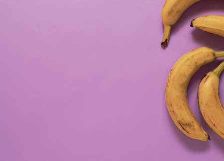 Bananas on pastel purple background, flat lay style minimalの写真素材