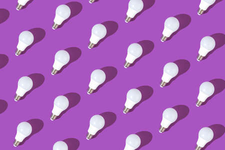 Glowing light bulbs against light purple background, flat lay pattern, minimal conceptの写真素材