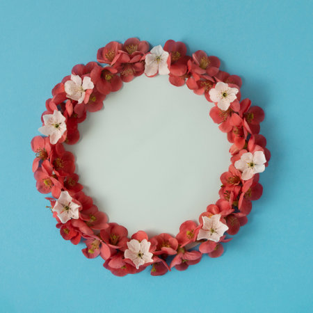 Red and white blossom flower wreath with rounded copy space, minimalistic flat lay spring concept on...