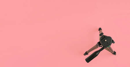Photographic tripod on pink background, top wiew banner with coppy spaceの写真素材