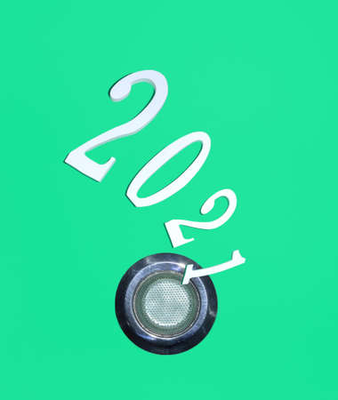 2021 goes to the kitchen sink. Minimal flat lay composition on pastel green background, funny New...