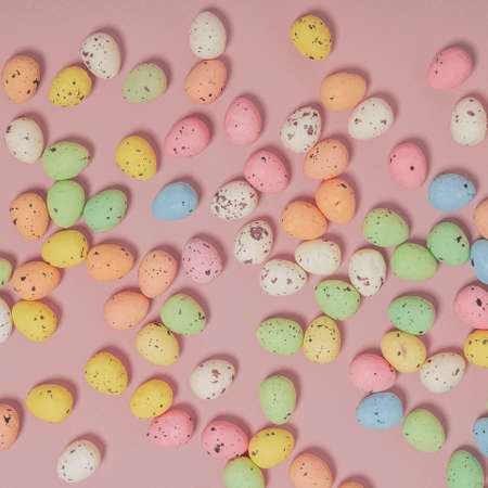 Easter eggs on a pastel pink background. Square flat lay pattern composition, minimal easter...