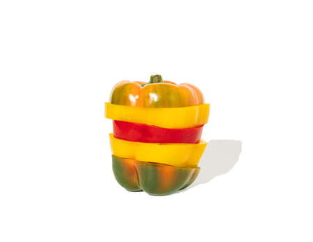 Sliced red, green and yellow paprikas like vegetable burger. Horizontal composition on white...