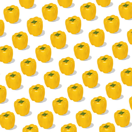 Whole yellow paprikas on white background. Seamless pattern, horizontal composition, minimal healthy nutrition concept designの写真素材