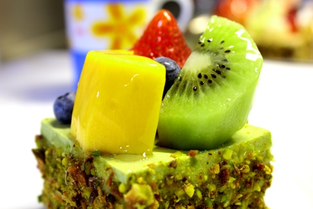 green tea cake on top fresh fruitの写真素材