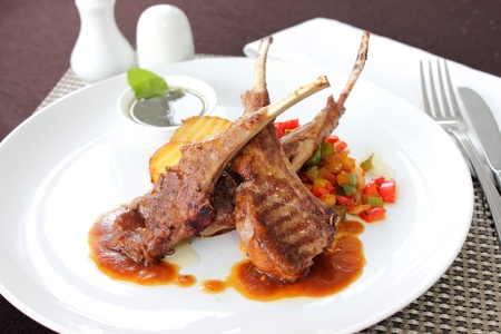 Lamb steak with sauce and boiled vegetablesの写真素材