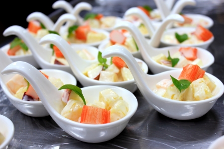 Potato salad and crab in White spoonの写真素材